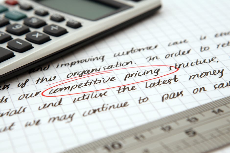 Focused image of handwritten business notes with calculator emphasizing pricing strategy.